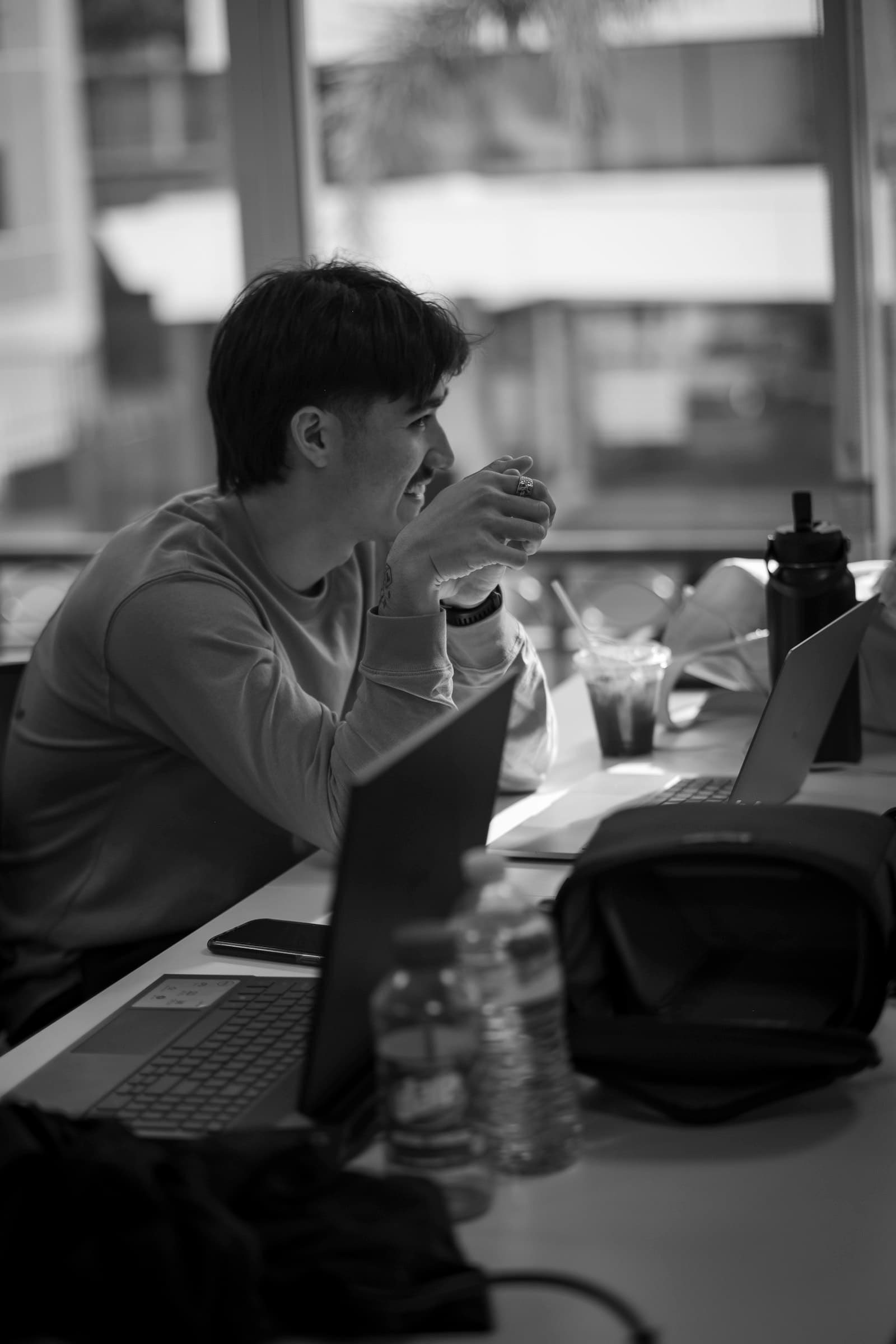 A student working on a laptop in a classroom setting.