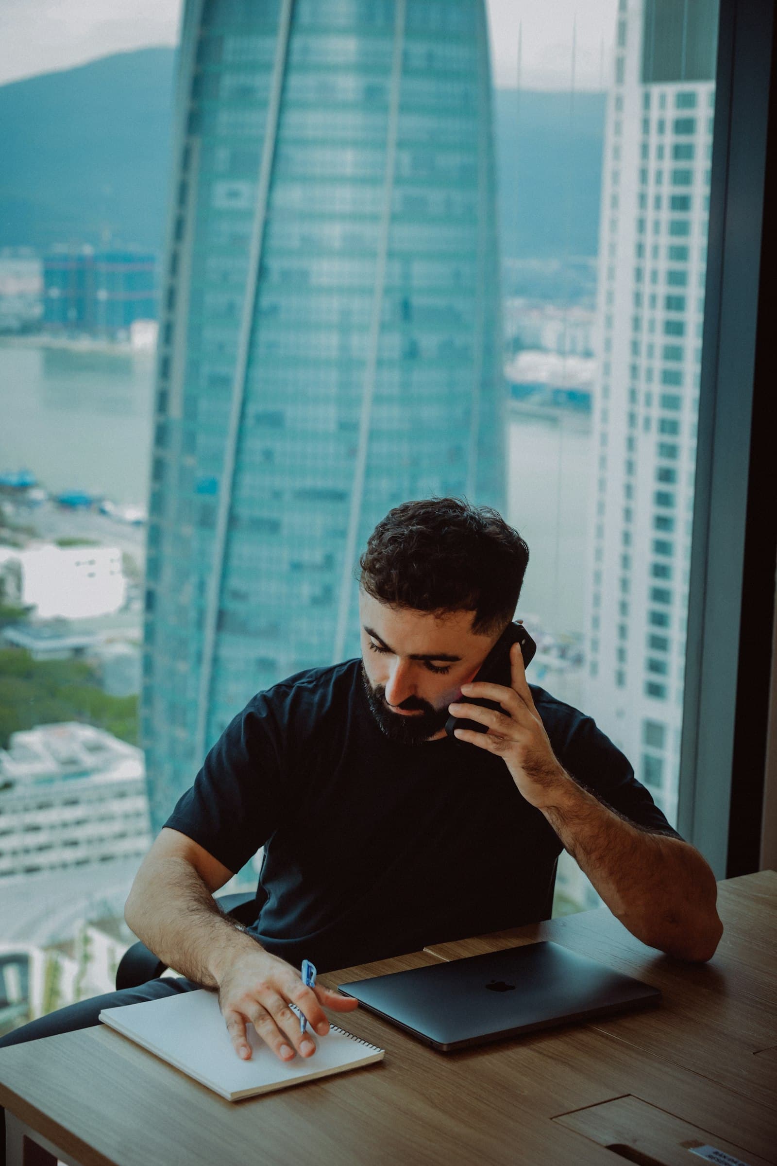 A desk setup with a laptop and phone for communication and support.